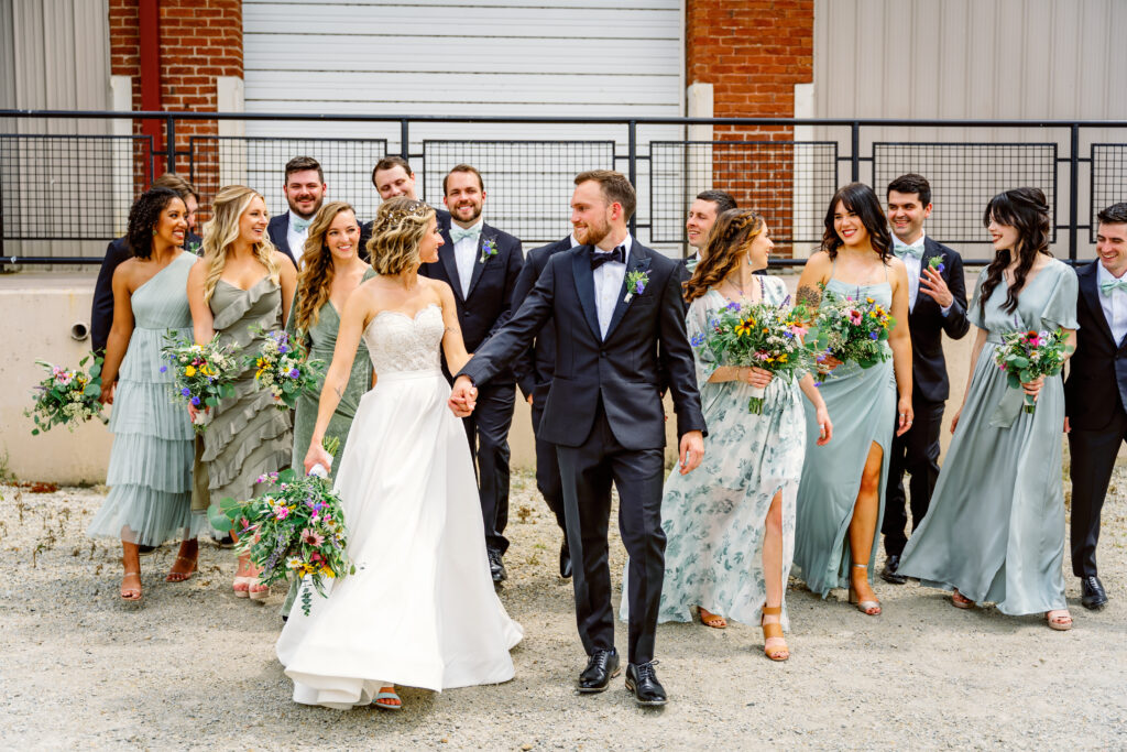 bridal party walking shot in an industrial park 