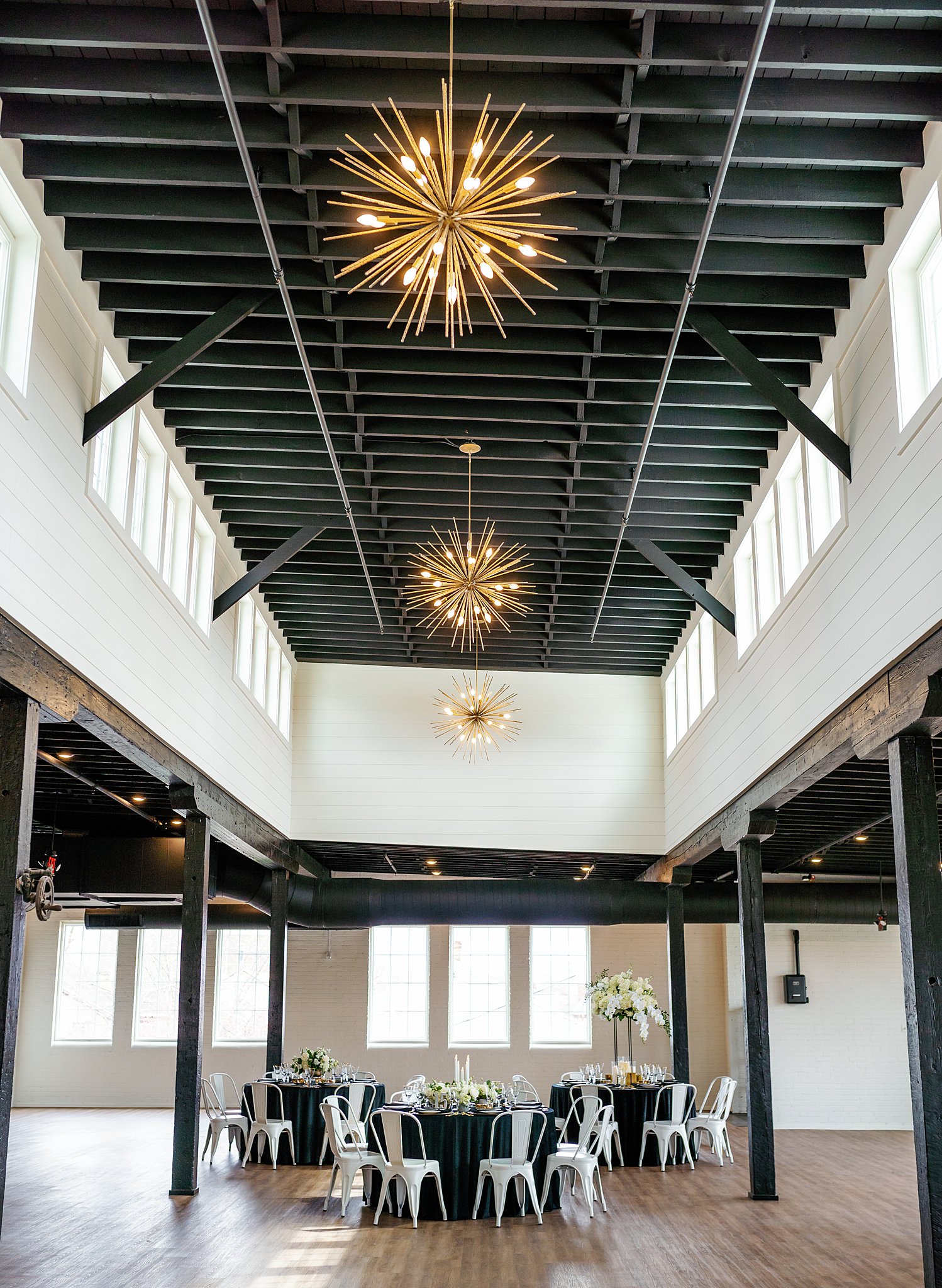 small wedding reception set up in a high ceiling room with exposed beams unique wedding venues dayton ohio